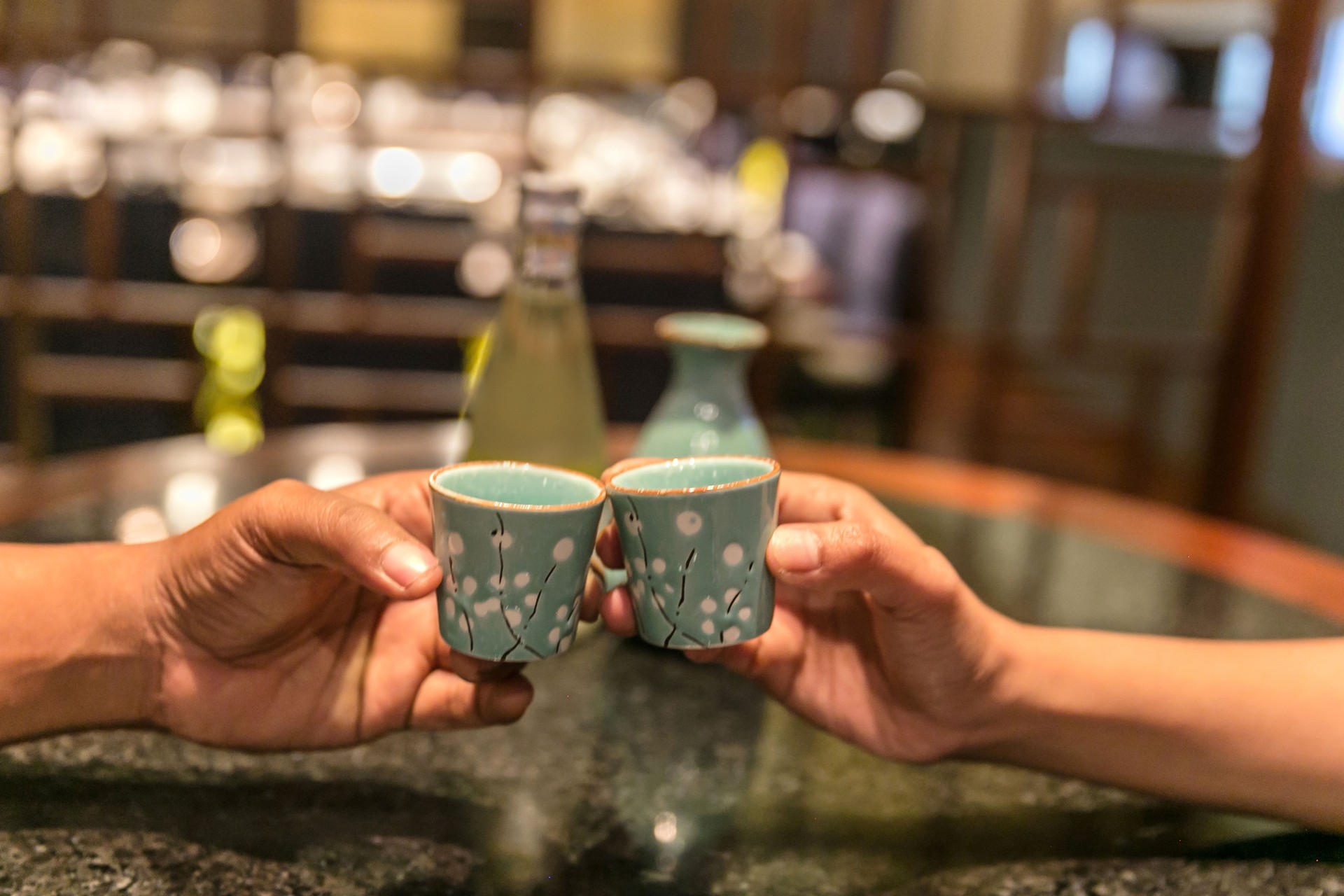 Japanese couple drinking sake on bar